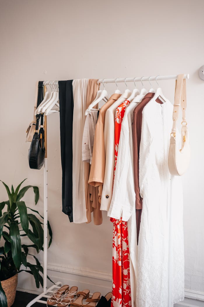 Home Stylish clothing rack with dresses and accessories in a boutique interior.