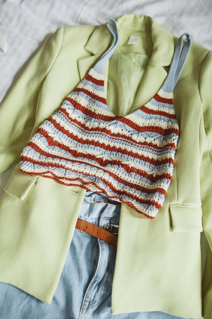 Home Fashionable knit crop top with striped pattern on a lime green blazer and denim jeans.
